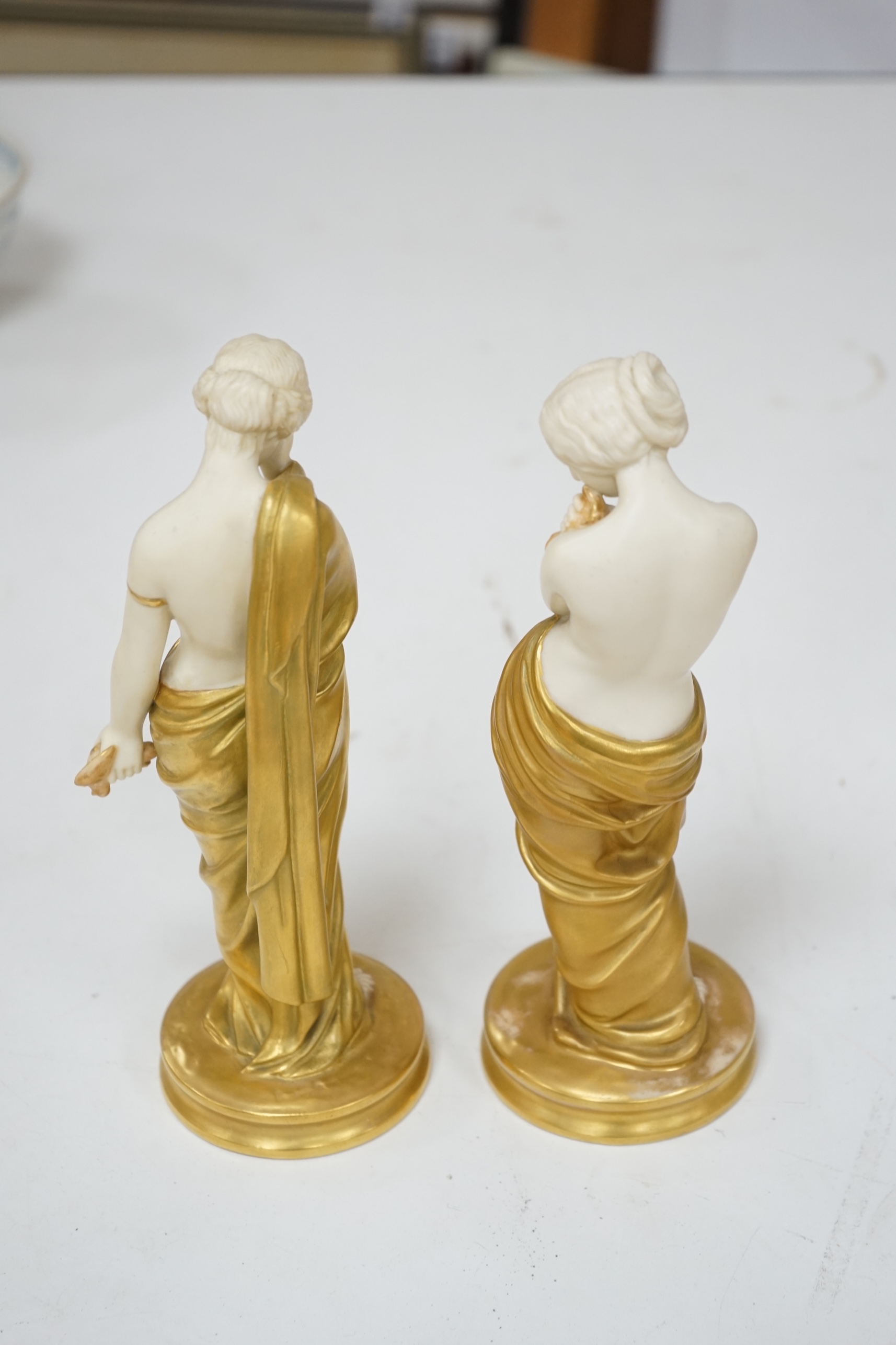 A pair of Royal Worcester porcelain figures, Joy and Sorrow, modelled by James Hadley, 2/57 & 2/47, 24cm. Condition - good